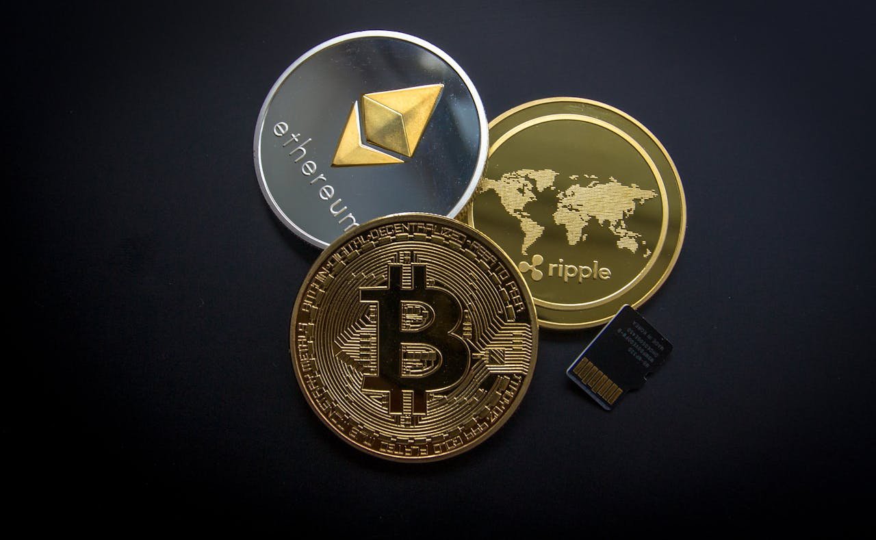 heros-img A striking image of Bitcoin, Ethereum, and Ripple coins illustrating modern digital currency.
